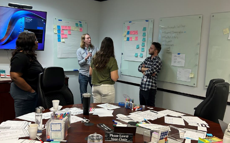 Designers chatting and giving feedback during the whiteboarding session.