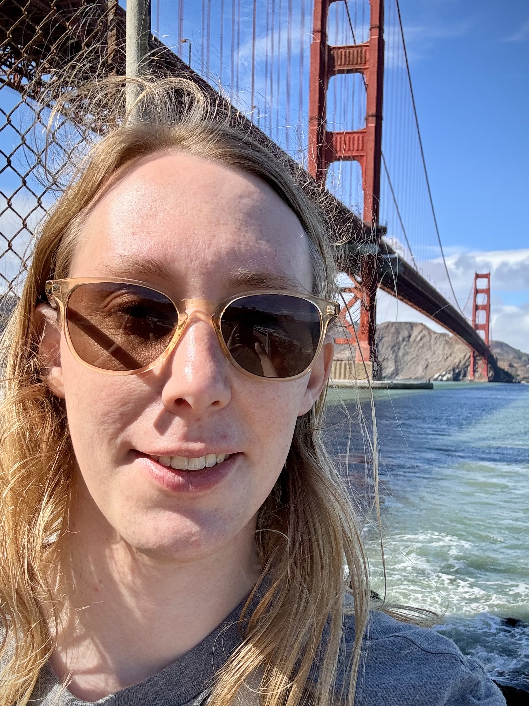 Picture of Stephen Pryor smiling with sunglasses and the Golden Gate Bridge in the background